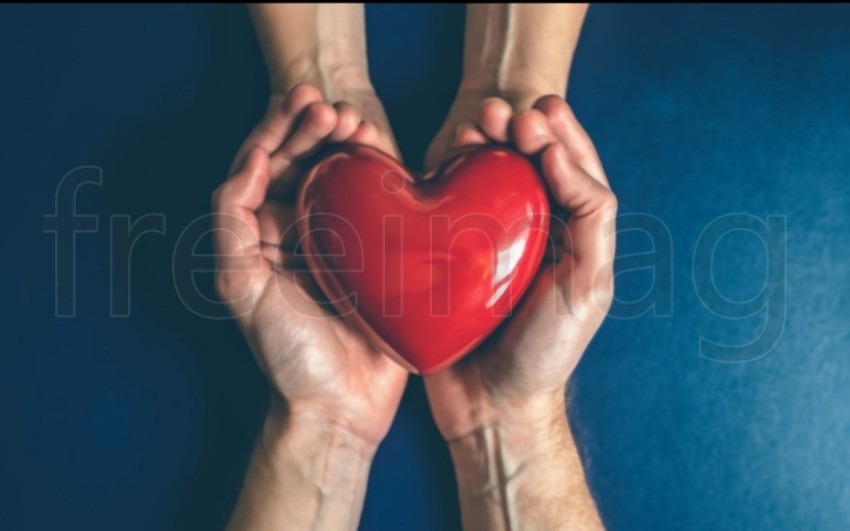 Dos manos  sostienen un corazón rojo sobre un fondo azul